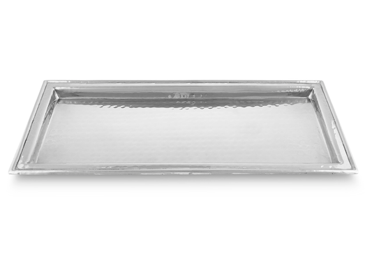 Close-up of hammered metal texture on luxury display tray"